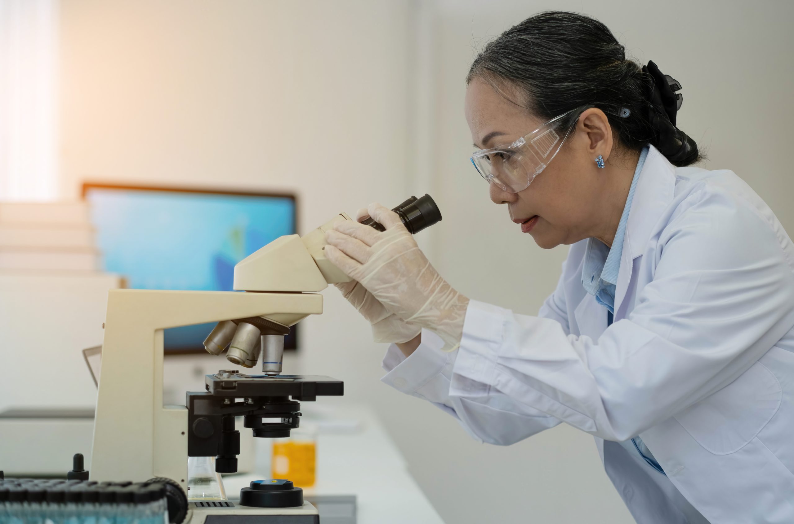 Medical Development Laboratory: Female Scientist Looking Under M